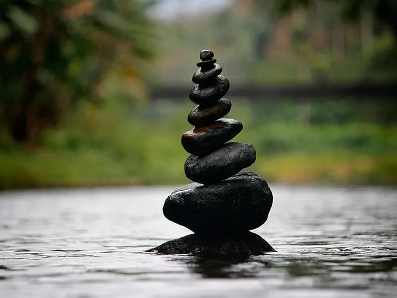 rocks stacked in shallow water
