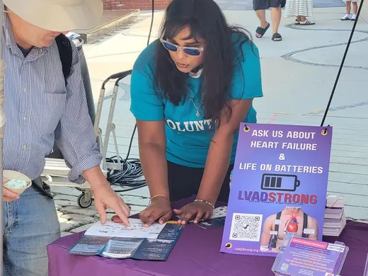 volunteer helping visitor at event