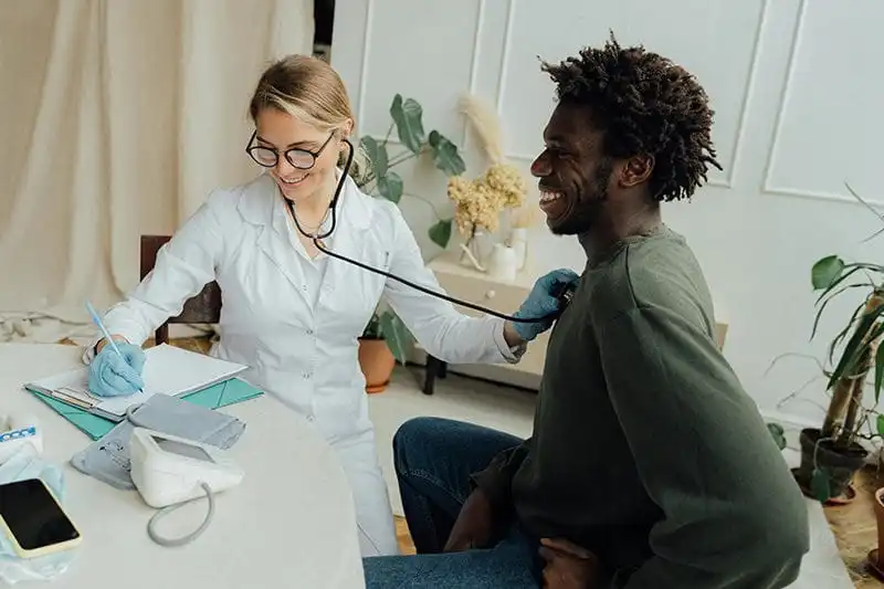 doctor using stethoscope on a patient