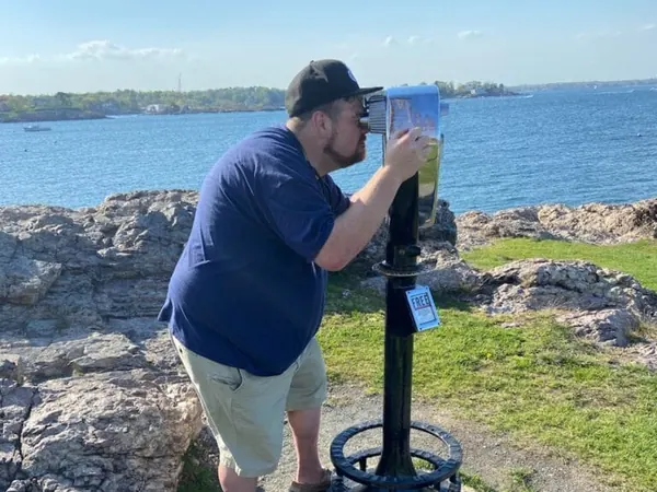 man looking through binoculars